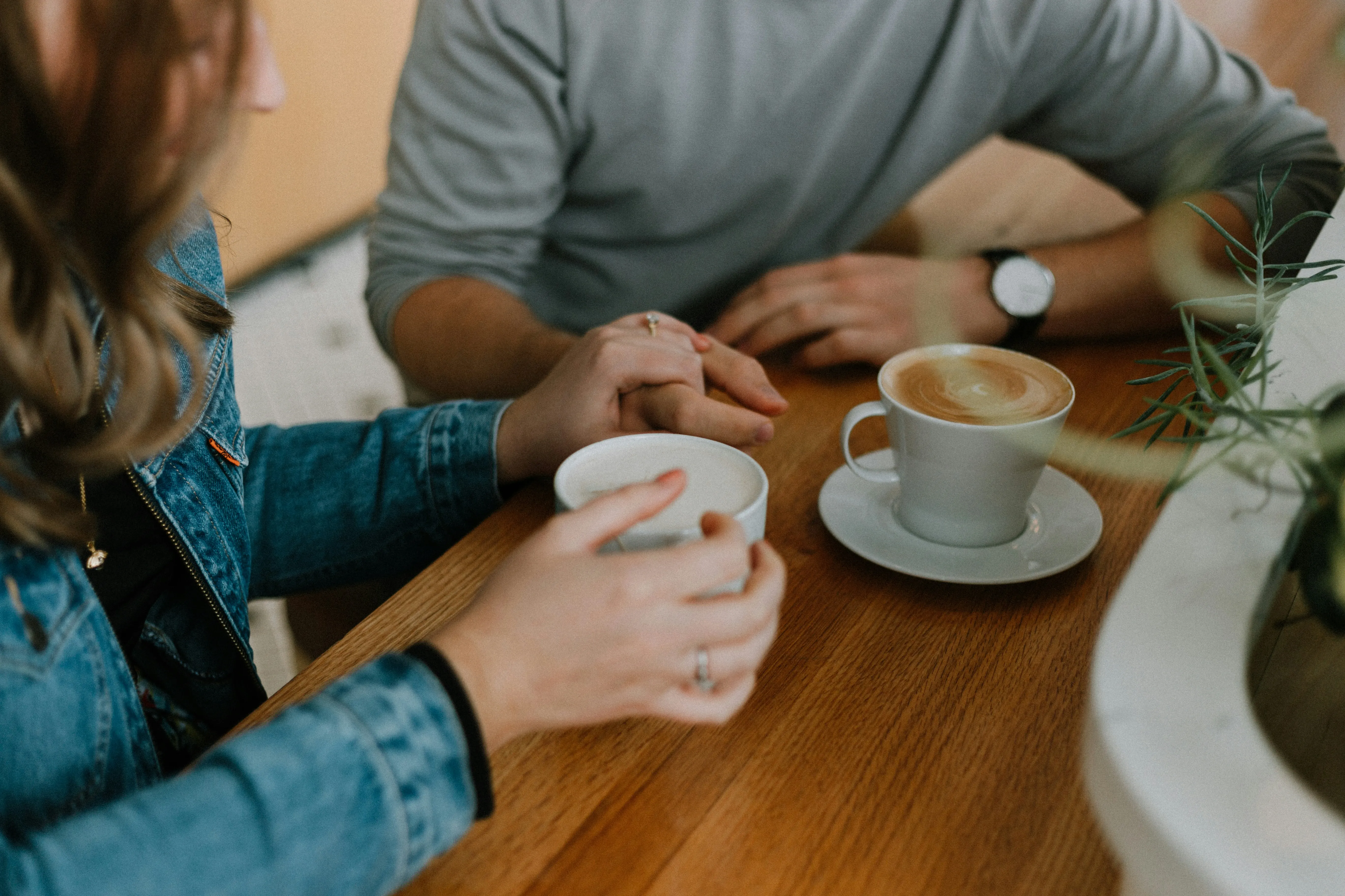Two people having a conversation over coffee
