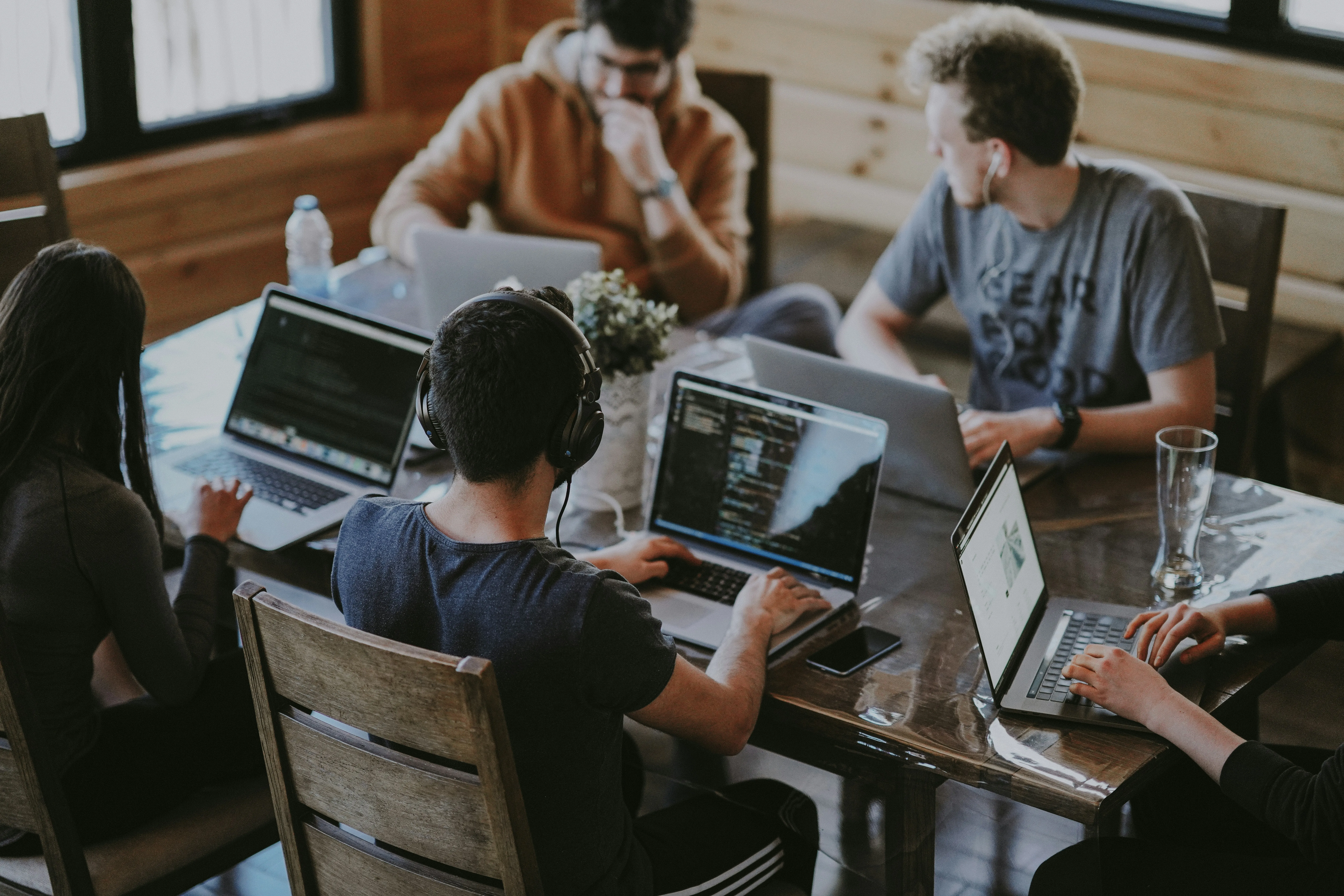 People working together around a table with laptops